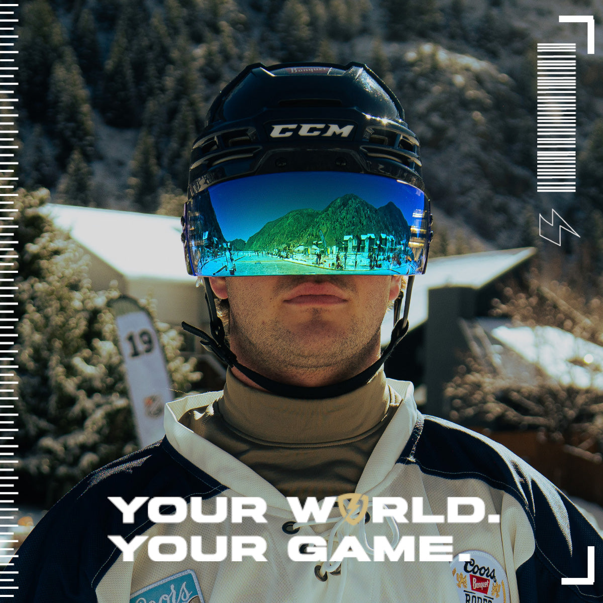 Person wearing a helmet with reflective blue SHOC Hockey Visor in a snowy landscape, with text 'Your World. Your Game.'
