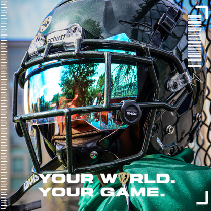 Youth Football Player wearing a Schutt F7 football helmet with a SHOC Clear Sky football visor, standing in front of a chain-link fence.