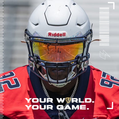Football player wearing a white Riddell SpeedFlex helmet with a SHOC Clear Sunset visor, featuring vibrant orange and gold reflective tones during game day action.