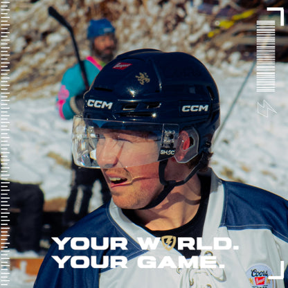 Person wearing a hockey helmet with a Clear SHOC Hockey Visor on a Snowy background