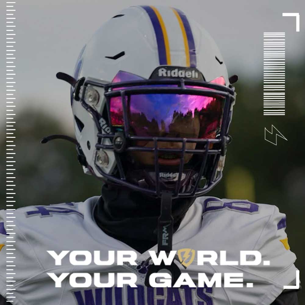 Person wearing a football helmet with a SHOC Tigers Blood Football Visor standing against a blurred background.